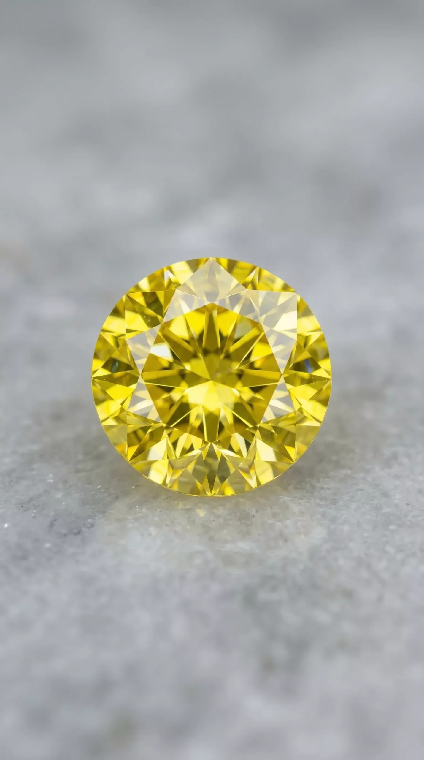 Top face view of natural vivid lemon yellow sapphire round cut 1.50 carats